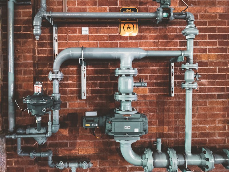 Plumber fitting a pipe with hand tools