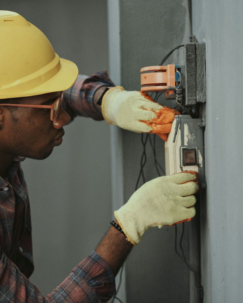 Plumber's hands working on copper pipework with a wrench